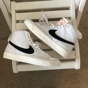 White, cream, and black high top Nike sneakers